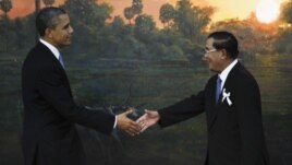 U.S. President Barack Obama, left, is greeted by Cambodia's Prime Minister Hun Sen before the ASEAN-U.S. leaders meeting in Phnom Penh, Cambodia, Monday, Nov. 19, 2012.  (AP Photo/Vincent Thian)