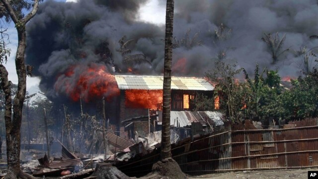 Smokes and flames billow from burning buildings in Sittwe, capital of Rakhine state in western Burma, where sectarian violence is ongoing, June 12, 2012.