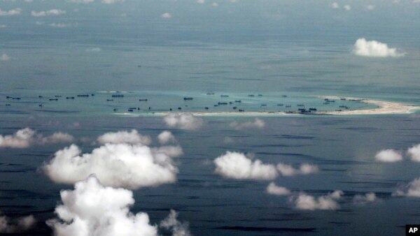 This photo taken through a window of a military plane shows China's apparent reclamation of Mischief Reef in the Spratly Islands in the South China Sea, May 11, 2015.