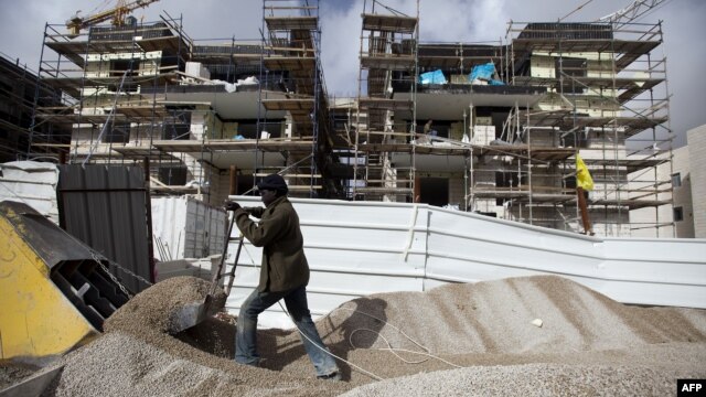 A labourer works at the construction site of a new housing project at the Jewish settlement of Gilo in east Jerusalem, December 20, 2012