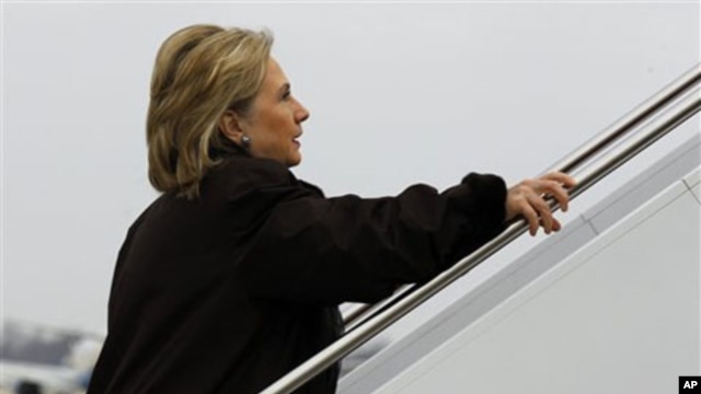 Secretary of State Hillary Clinton boards her plane for a trip to Haiti at Andrews Air Force Base outside of Washington, DC, January 30, 2011