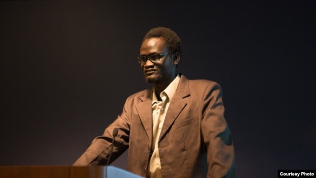 George Washington graduate Makwei Deng speaking to students and supporters. (William Atkins/The George Washington University)