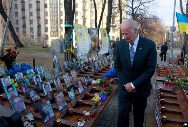 U.S. Vice President Joe Biden pays his respects at a memorial honoring dozens of demonstrators killed during 2013-1014 anti-government protests in Kyiv, in Ukraine's capital, Dec. 7, 2015.