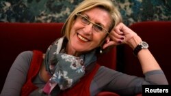 Rosa Diez, leader of the centrist Union for Democracy and Progress, or UPyD, smiles while posing for a photograph in Parliament in Madrid, May 21, 2013. 