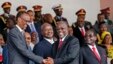 Tanzania's newly elected president John Magufuli (2ndR) shakes hands with Rwanda's president Paul Kagame (L) eyed by Zimbabwe's president Robert Mugabe (R) and Uganda's president Yoweri Museveni (2ndL) during the swearing in ceremony in Dar es Salaam, on Nov. 5, 2015.