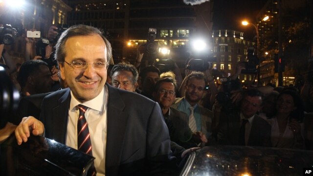 Leader of the New Democracy conservative party Antonis Samaras leaves an elections kiosk after speaking to his supporters at Syntagma square in Athens, Sunday, June 17, 2012.