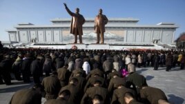 North Korean soldiers bow before the statues of late leaders Kim Il Sung, left, and Kim Jong Il, right, at Mansu Hill in Pyongyang, North Korea, December 17, 2012.
