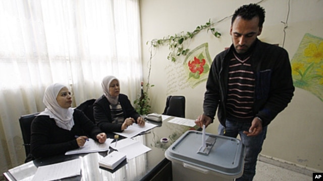 A man casts his vote in Damascus, Syria, December 12, 2011.