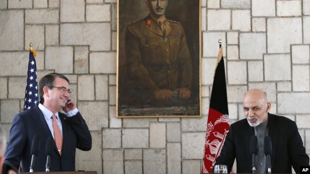 U.S. Defense Secretary Ash Carter, left,  listens to remarks by Afghan President Ashraf Ghani during a news conference at the Presidential Palace in Kabul, Feb. 21, 2015.  