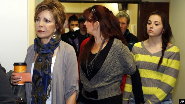 Family members and victims line up to get into court for a preliminary hearing for Aurora theater shooting suspect James Holmes at the courthouse in Centennial, Colorado, Monday, Jan. 7, 2013. 