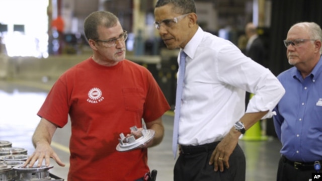 President Barack Obama talks with employees Mike Clements, right, and Richard Thomas during a tour at Allison Transmission in Indianapolis, Ind., May 6, 2011.