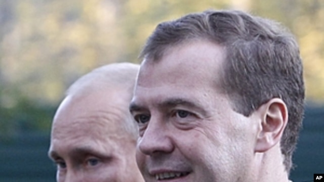 Russian President Dmitry Medvedev, right, and Prime Minister Vladimir Putin walk at the presidential residence in Zavidovo, about 150 kilometers (90 miles) north of Moscow, Russia.