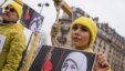 FILE - A demonstrator poses with a symbolic rope around her neck as Iranian opposition protesters march during a rally to protest against executions in Paris, France.