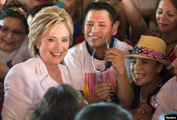 FILE - Democratic U.S. presidential candidate Hillary Clinton poses with supporters after a "Latinos for Hillary" rally in San Antonio, Texas, Oct. 15, 2015.