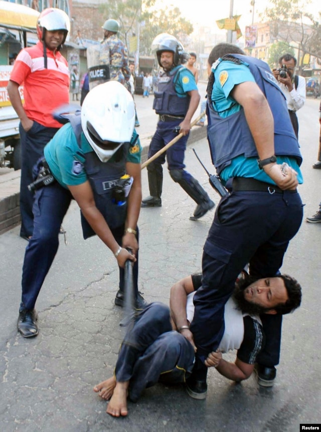 A policeman uses a baton on an activist of Jamaat-e-Islami, Bangladesh's biggest Islamist party, during a clash at Jatrabari in Dhaka, Feb. 28, 2013.