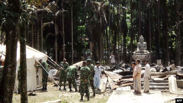 Soldiers from the Bangladesh Army erect tents at the torched Lal Ching Buddhist temple at Ramu, some 350 kilometers  from the capital Dhaka, October 1, 2012.