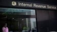 A woman walks out of the Internal Revenue Service building in New York, May 13, 2013.