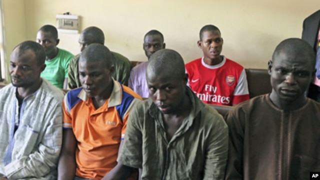 Men believed to be members of Islamist sect Boko Haram and suspected of being involved in a series of bomb attacks wait for the start of a court session at the Wuse magistrate court in Abuja, September 13, 2011.