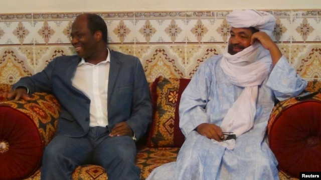 Iyad Ag Ghali, right, leader of Ansar Dine, meets with Burkina Faso foreign minister Djibril Bassole in Kidal, northern Mali, August 7, 2012.