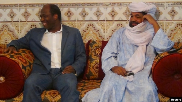 Iyad Ag Ghali, right, leader of Ansar Dine, meets with Burkina Faso foreign minister Djibril Bassole in Kidal, northern Mali, August 7, 2012.