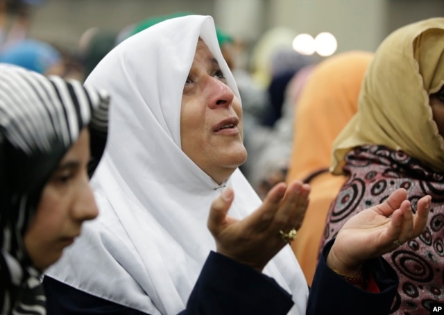 A Muslim woman prays before Muhammad Ali's Jenazah, a traditional Islamic service, at Freedom Hall in Louisville, Ky., June 9, 2016.