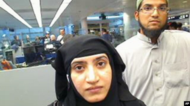 This July 27, 2014 photo provided by U.S. Customs and Border Protection shows Tashfeen Malik, left, and Syed Farook, as they passed through O'Hare International Airport in Chicago.