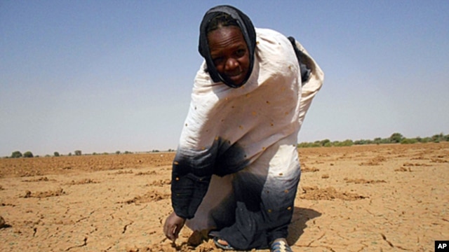 Image released by Oxfam shows a women pointing at the dry land in Oud Guedara. Early indicators point to a likely food crisis in 2012, with people at particularly high risk in Mauritania, Niger, Burkina Faso, Mali and Chad, December 11, 2011.
