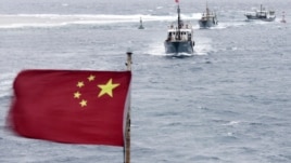 Chinese fishing boats sail in the lagoon of Meiji reef off the island province of Hainan in the South China Sea, July 20, 2012.