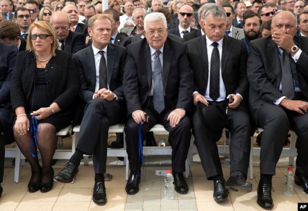 Palestinian President Mahmoud Abbas, center, sits next to European Council President Donald Tusk, second left, during the funeral of former Israeli President Shimon Peres at Mt. Herzl Military Cemetery in Jerusalem, Sept. 30, 2016.