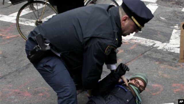 A policeman arrests a Occupy Wall Street protester in New York, Thursday, Nov. 17, 2011