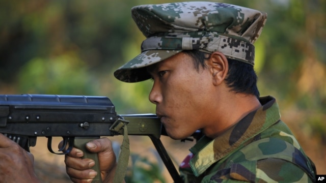  Kachin soldier mans a frontline position, facing off against Burmese government troops about 15 kilometers (9 miles) from the headquarters of the Kachin Independence Organization, in Laiza, Feb 13, 2012.