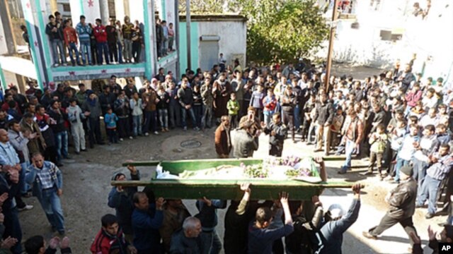 Anti-government protesters carry the coffin of Abdul Haleem Baqour during his funeral in Hula near Homs, Syria, December 10, 2011. Baqour was killed by shrapnel during shelling by the government army on Hula last week.