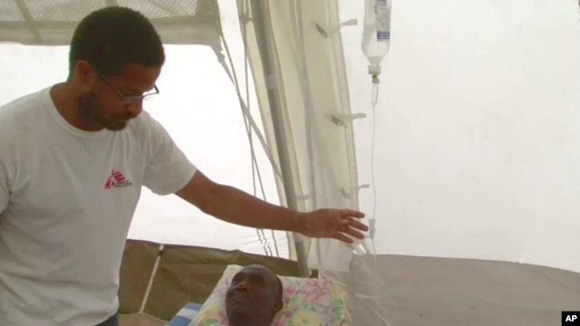 Nigerian-born Dr. Chibuzo Okonta with Doctors Without Borders attends to a patient in Port-au-Prince