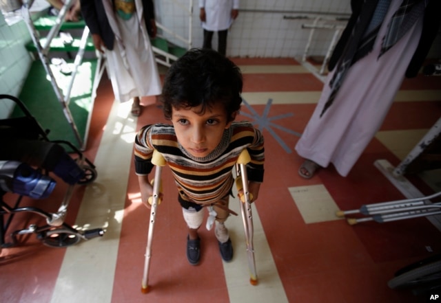 FILE - A young boy who lost his leg in the Yemen war uses a prosthetic limb at a government-run rehabilitation center in Sana'a, Yemen, Saturday, March 5, 2016.