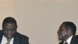 Zimbabwean President Robert Mugabe, right, chats to Prime Minister Morgan Tsavangirai during their end of year press conference at State House in Harare, saying they were dispelling rumors of disunity in the Government of National Unity, Dec. 20, 2010 