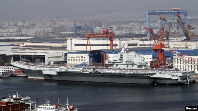 A general view shows navy soldiers standing on China's first aircraft carrier 'Liaoning' as it is berthed in a port in Dalian, northeast China's Liaoning province, September 25, 2012. 