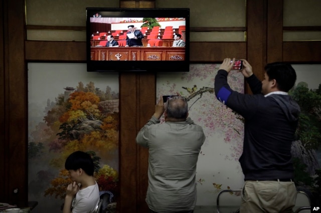 FILE - Restaurant diners watch a broadcast of the seventh congress of the Workers' Party of Korea on local television, where North Korean leader Kim Jong Un is seen delivering a speech, in Pyongyang, May 6, 2016.