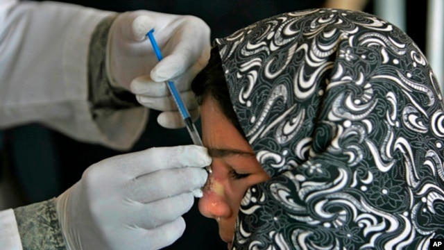 An Afghan woman affected by leishmaniasis gets an injection at a free specialized clinic for supported by World Health Organization in Islam Qala, Herat, Afghanistan,  Oct. 30, 2010.