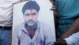 Family members of Sarabjit Singh hold his picture to appeal for his release during a demonstration in the northern Indian city of Amritsar June 25, 2009. Pakistan