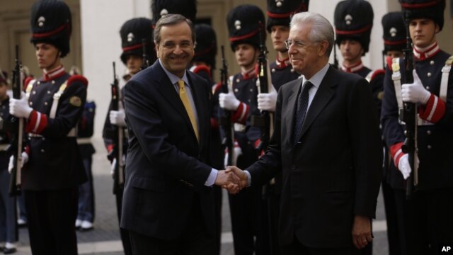 Italian premier Mario Monti, right, shakes hands with Greek Prime Minister Antonis Samaras, at Palazzo Chigi government office, in Rome, September 21, 2012.