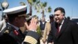FILE - This image released by the media office of the unity government shows Fayez al-Sarraj, right, upon his arrival in Tripoli, Libya, March 30, 2016. He arrived by sea with six deputies to set up a temporary seat of power in a naval base.