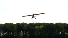 Ray Gefken takes flight in his ultralight, single-seat airplane. (Mary Saner/VOA)