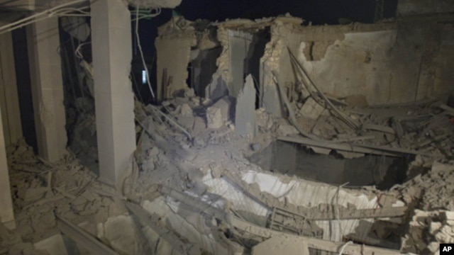 In this photo taken on a government organized tour, ruins of an official building are seen following an air strike in Tripoli, Libya, early Tuesday, May 10, 2011.