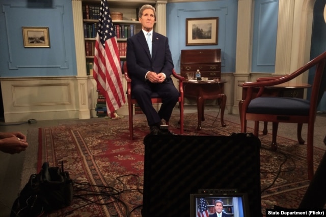 U.S. Secretary of State John Kerry settles into his chair in a studio at the Department of State in Washington, D.C., before appearing on the MSNBC program 