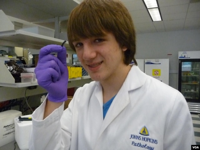 Jack Andraka, 16, with his pancreatic cancer sensor strip at the Johns Hopkins lab in Baltimore. (Courtesy Jane Andraka)