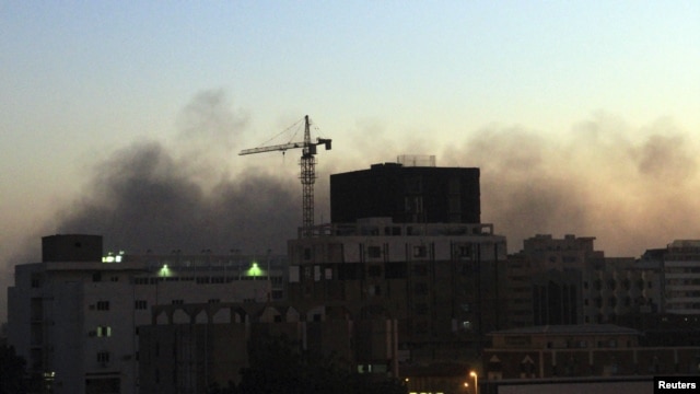 Smoke rises over central Khartoum as cars burn during demonstrations over the deaths of four students from war-torn Darfur, December 9, 2012.