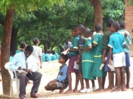 Primary school teacher marks students' work in Malawi's southern district of Phlombe.