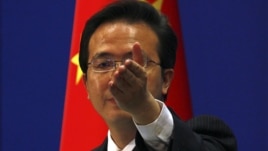 China's Foreign Ministry spokesman Hong Lei asks journalists for questions during a news conference in Beijing, July 7, 2011.