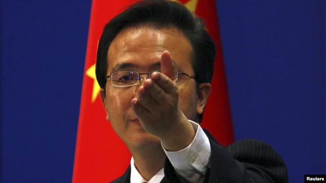 China's Foreign Ministry spokesman Hong Lei asks journalists for questions during a news conference in Beijing, July 7, 2011.