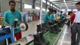 People work on the assembly line at Huajian shoe factory in Dukem, Ethiopia, April 19, 2012.